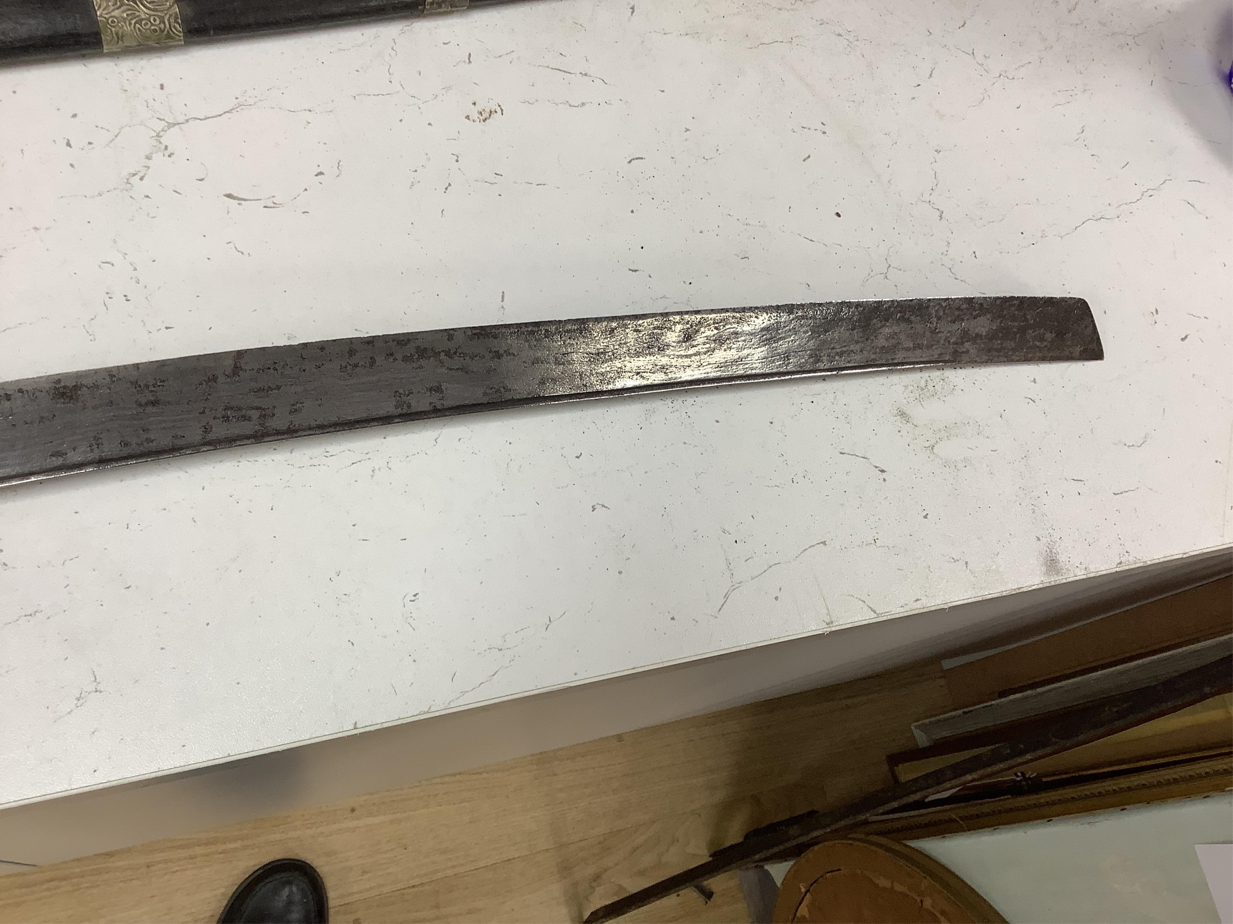 Four bladed weapons; an Indian sword Tulwar, blade 68.5cm. Condition - poor, heavily pitted., A Nepalese Kukri. Condition - fair., A Thai sword Dha, with a lacquered hilt and wooden scabbard, blade 56cm. Condition - fair